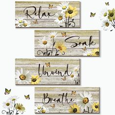 three wooden signs with daisies and butterflies on them