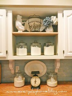 an open cabinet with jars and other items on it