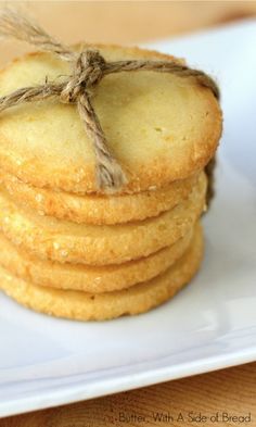 a stack of shortbread cookies tied with twine and sitting on a white plate