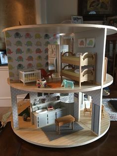 a doll house with furniture and accessories inside