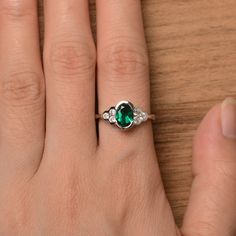 It is a lab emerald ring. The main stone is 6 mm*8 mm oval cut.weight about 1.13 carats. The basic metal is sterling silver and plated with rhodium. To change the metal to a solid gold (white/rose) or platinum is also available, please ask for a quotation if you want. You can also go to my shop Home for more elegant rings: https://www.etsy.com/shop/godjewelry?ref=hdr_shop_menu Emerald is the May birthstone More emerald rings: https://www.etsy.com/shop/godjewelry?section_id=20709240 Customization Oval Emerald May Birthstone Ring, Oval Emerald Birthstone Ring For May, Oval Emerald Ring With Birthstone, Oval Emerald Promise Ring, Silver Oval May Birthstone Ring, Green Oval Sterling Silver Birthstone Ring, Oval Emerald Birthstone Ring For Anniversary, Oval May Birthstone Ring For Promise, Oval Emerald Anniversary Birthstone Ring