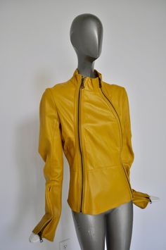 Great leather jacket made by Nolita NYC. The jacket is in very good pre-owned condition, bright yellow color, two zippers on front. There are no pockets no lining. Supple leather. Nolita was a great design company for clothing from Brooklyn NY. The sleeves have also metal zippers inserted on the side. Please inquire with questions. Free domestic shipping, get 15% discount w code crazyfashion Measures Length 21 inch Shoulder 16 inch Bust 34 inch all around Sleevelength 26 inch Waist 30 inch Yellow Leather Jacket For Winter, Yellow Leather Jacket With Long Sleeves, Yellow Fitted Long Sleeve Biker Jacket, Fitted Yellow Biker Jacket For Fall, Yellow Long Sleeve Leather Jacket, Yellow Leather Jacket For Spring With Long Sleeves, Yellow Long Sleeve Leather Jacket For Spring, Nolita Nyc, Cruella Costume