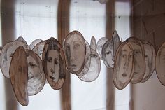 some paper faces are hanging on the wall