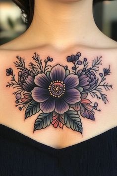 a woman's chest with flowers and leaves tattooed on her upper half - arm