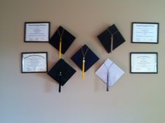 graduation caps and diplomas hanging on the wall