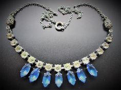 For sale is this lovely vintage necklace dating from around the 1940's. It features blue and clear glass paste stones, claw set into white metal. The rest of the necklace is made up of white metal chain with two decorative white metal connectors. The length of the necklace is 42cm which is inclusive of the working bolt ring fastener. It is in very good vintage condition with all stones and claws present and just very light surface wear in keeping with age. Very pretty! Scarab Bracelet, Bolt Ring, Crystal Bead Necklace, Vintage Boots, Gorgeous Bracelet, Glass Bead Necklace, Glass Necklace, White Metal, Vintage Art Deco