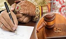 a person writing on a piece of paper next to a judge's gavel