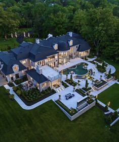 an aerial view of a large mansion in the evening