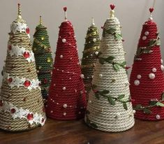 small christmas trees made out of rope on a table