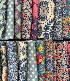 many different types of fabrics are arranged together in rows and stacked on top of each other