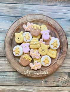 a plate full of decorated cookies sitting on top of a wooden table