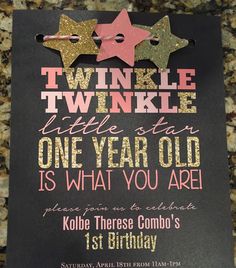 a birthday card with two little stars on the front and one year old on the back