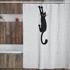 a shower curtain with a black cat on it