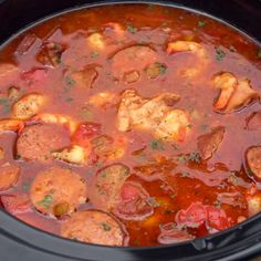 a crock pot filled with meat and vegetables