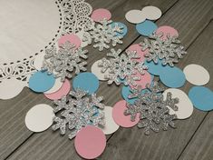 paper snowflakes and doily on a table