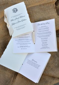 the wedding stationery is laid out on top of each other and ready for guests to arrive