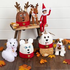 an elf is sitting on a bench surrounded by stuffed animals and other holiday decor items