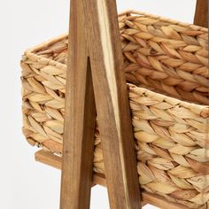 a close up of a wooden chair with a basket on it