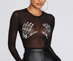 Get a bad to the bone spooky costume in this mesh graphic crop top. It features a crew neckline. long fitted sleeves. a cropped hem. and contrasting hued skeleton hands. Top is sheer and offers plenty of stretch. Be sure to grab the matching accessories to complete your Halloween costume!Model is 5'8" with a 32" bust. 23" waist. and 36" hips. She is wearing a size small. Black Crew Neck Mesh Top For Club, Black Gothic Top With Sheer Sleeves, Black Sheer Mesh Top Gothic Style, Gothic Tops With Sheer Sleeves For Night Out, Black Punk Mesh Top With Mesh Sleeves, Fall Party Graphic Print Mesh Top, Fall Party Mesh Top With Graphic Print, Black Long Sleeve Punk Mesh Top, Long Sleeve Mesh Top Punk Style