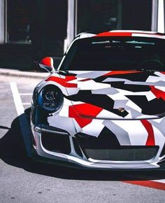 a white and red sports car parked in a parking lot