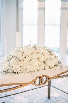 a bouquet of white flowers sitting on top of a table