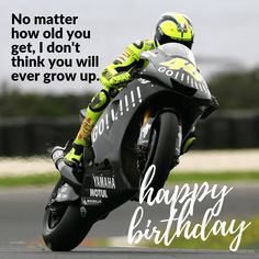 a person riding a motorcycle on top of a race track with a happy birthday message