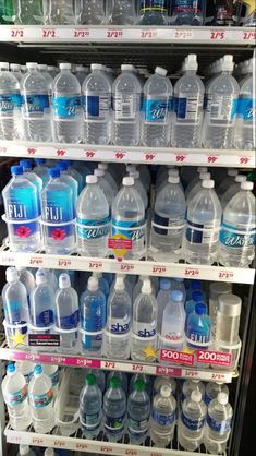 water bottles are stacked on shelves in a store