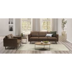 a living room with two couches and a coffee table in front of the window