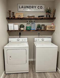 a washer and dryer in a laundry room with shelves on the wall above them