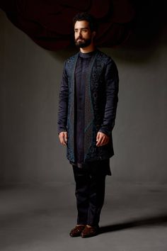 Editor's Note Featuring our midnight wane shrug set with the mastery of guipure-like embroideries and lace fluttering with a contrasting peacock green thread. Paired with a matching shoulder button embroidered kurta and tapered trousers. Fabric: Linen silk Color: Blue Components: Shrug, kurta, trousers Occasion: Wedding guest Fit: Regular Note: Product colour may slightly vary due to photographic lighting sources Care: Dry clean only About the Designer After establishing himself as the leading c Blue Shrug, Blouse Yoke, Green Thread, Personal Shopping Service, Dhoti Pants, Nyc Studio, Royal Look, Haldi Ceremony, Indian Man