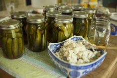 pickles and cheese in jars on a table