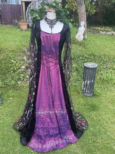 "🕷FREE CHOKER 🕷  WITH THIS PURCHASE  THIS STUNNING ENCHANTED ORIGINAL HAND CRAFTED DRESS HAS BEEN  FASHIONED  IN THE PRINCESS LINE STYLE  IT IS MADE FROM IN A LUXURIOUS TRULY GORGEOUS MIDNIGHT BLACK CRUSHED VELVET  (CONTAINING LYCRA) ...    IDEAL FOR  A  MEDIEVAL / RENAISSANCE THEMED BALL, PARTIES, SAMHAIN / HALLOWEEN 🎃 , HANDFASTINGS / WEDDINGS, OR ANY SPECIAL, SACRED OCCASION, FOR THAT EXTRA WOW FACTOR   THE  FLOOR LENGHT MEDIEVAL CAPE STYLE SLEEVES HAVE BEEN FASHIONED FROM A STUNNING  BREA Gothic Ball Gown For Halloween, Bohemian Halloween Cosplay Dress, Bohemian Halloween Costume Dress, Fitted Witchy Medieval Dress For Fantasy Events, Fitted Medieval Dress For Fantasy Events, Gothic Floor-length Costume Gown, Gothic Victorian Dress For Larp At Halloween, Fitted Witchy Medieval Dress For Larp, Gothic Overbust Dresses For Festivals