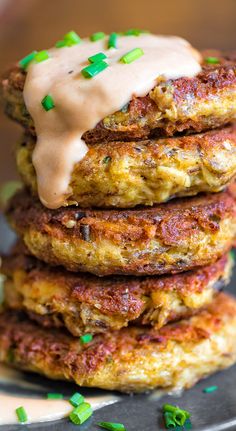 a stack of food that is sitting on top of a metal plate with green sprinkles