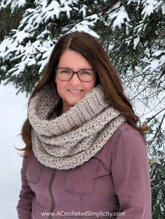 a woman wearing glasses and a scarf in the snow