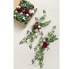 three bouquets of flowers and greenery in a box on a table with the same design