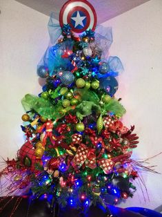 a christmas tree decorated with ornaments and lights in the shape of a captain's shield