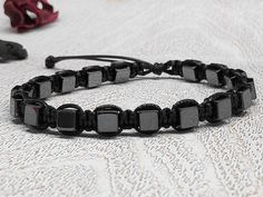 Adjustable men's bracelet with natural hematite cube beads, braided bracelet with black nylon 1mm cord. * Diameter of the beads: 5 mm It has strong slide simple knot-lock, to open and close the bracelet, and in the end a Diamond Knot. Please select your length from the drop down menu. We can customize this to any length, just leave me a note at checkout or contact me. Healing mineral crystal- protection- spiritual- calming- meditation- chakra stone- yoga stone- energy natural stone. Handmade art Adjustable Black Rectangular Beaded Bracelets, Adjustable Black Hematite Beaded Bracelets, Macrame Black, Men Stone Bracelet, Quartz Crystal Jewelry, Diamond Knot, Bracelet Macrame, Cube Beads, Hematite Bracelet