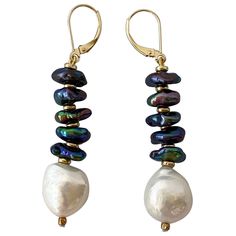 These stunning earrings feature bright iridescent Black oil spill / peacock Pearls separated by contrasting Gold plated Roundales. The bright contrast between the textured Black Pearls and Gold is perfectly balanced with a large smooth Baroque White Pearl at the end. These earrings measure 2.5 inches long and a versatile and a perfect fit for any vibrant personality. **All jewelry is handmade by designer for any custom sizing, color, material,or any other requests, please contact Marina J. Price Black Pearl Jewelry, Iridescent Black, Peacock Pearls, J Black, Oil Spill, Black Oil, Stunning Earrings, Black Pearl, Baroque Pearls