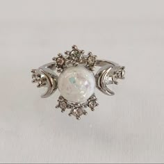 Silver Plated, White Opal (Simulated) Celestial Ring. Features The “Sun”, “Moon”, And “Stars” Represented By The Different Stones. Item Is A Size 6, New, And Unworn. Please Note, The Photos Are Of The Size 6 Ring. I Also Have This In A Size 5 And That Ring Looks Like The One Shown In The Photos But It Won’t Be The Actual Ring In The Photo. Also, Please Ask Me Any Questions You May Have Prior To Making A Purchase. Lunar Engagement Ring, Opal Moon Engagement Ring, Opal Moon Ring, Opal And Silver Engagement Ring, Moon Engagement Ring Silver, Witchy Promise Rings, Jem Stone Engagement Rings, Gemstone Wedding Rings Silver, Opalite Wedding Ring