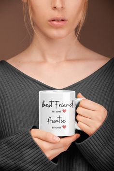 a woman holding a coffee mug with the words best friend on it