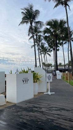 the entrance to a resort with palm trees in the background