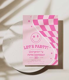 a pink and white birthday party card on top of a plate with the words let's party