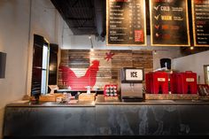 the interior of a coffee shop with menus on the wall