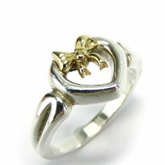 Used Tiffany & Co. Ring Heart Ribbon Silver 925 K18yg Approx. 3.5g Yellow Gold Women's Tiffany (Sku: Gzl14mjk) === General === Brand : Tiffany Line : Heart === Design === Type : Band Ring Gender : Women Color : Silver, Yellow Gold Material : Silver 925, Yellow Gold (18k) === Size === Other Size : 10.5 Width : 4.3mm / 0.17'' Weight : 3.5g / 0.12oz. === Included Items === Accessories Notice : Before Purchasing, Please Refer To The Images Of The Accessories Included With The Item. === Condition === Tiffany Co Rings, Heart Ribbon, Ring Heart, Tiffany Jewelry, Wedding Plans, Woman Colour, Heart Design, Gold Material, Tiffany & Co.