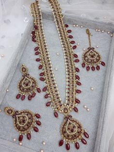 "This Beautiful Antique Gold Polki Stone Long Mala Necklace  Rani Haar Set for all Vibrant colors for your special events. Set Includes: Necklace, Tikka and Earrings Jewellery Care -- Keep all the jewellery away from water, perfumes, and other harsh chemicals To clean wipe with a lint-free cloth to retain the shine Dimension:- necklace:- Length 15\" Earrings:- Drop Length 4\" Approximately. Please Note- No Returns No Exchange" Gold Long Bridal Necklace For Wedding, Elegant Tikka For Marriage And Festivals, Elegant Marriage Tikka For Festivals, Temple Jewelry Style Bridal Long Necklace For Wedding, Temple Jewelry Style Long Bridal Necklace For Wedding, Red Long Necklace For Wedding, Traditional Long Necklace For Wedding Festivals, Elegant Long Kundan Necklace For Wedding, Traditional Long Necklace For Wedding