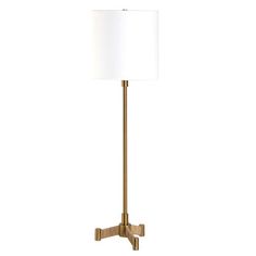 a floor lamp with a white shade on the base and a gold colored metal frame