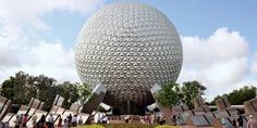 people are standing in front of an egg shaped building at the epcoti disney world