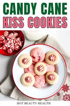 candy cane kiss cookies on a white plate next to a red and white striped bowl