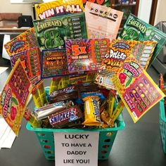 a basket filled with lots of candy sitting on top of a table next to a sign