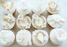 cupcakes decorated with white and gold decorations